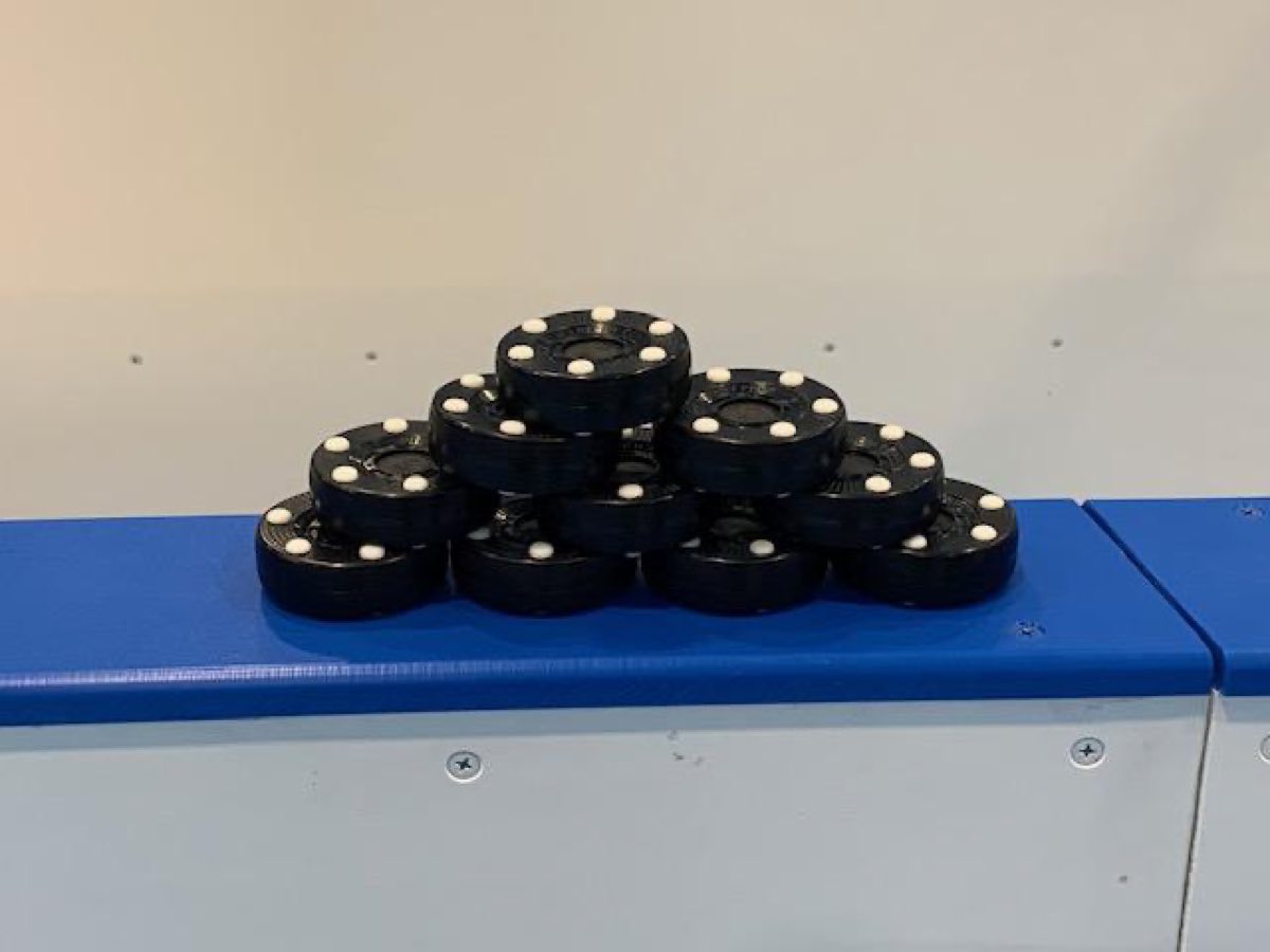A stack of inline pucks on the boards