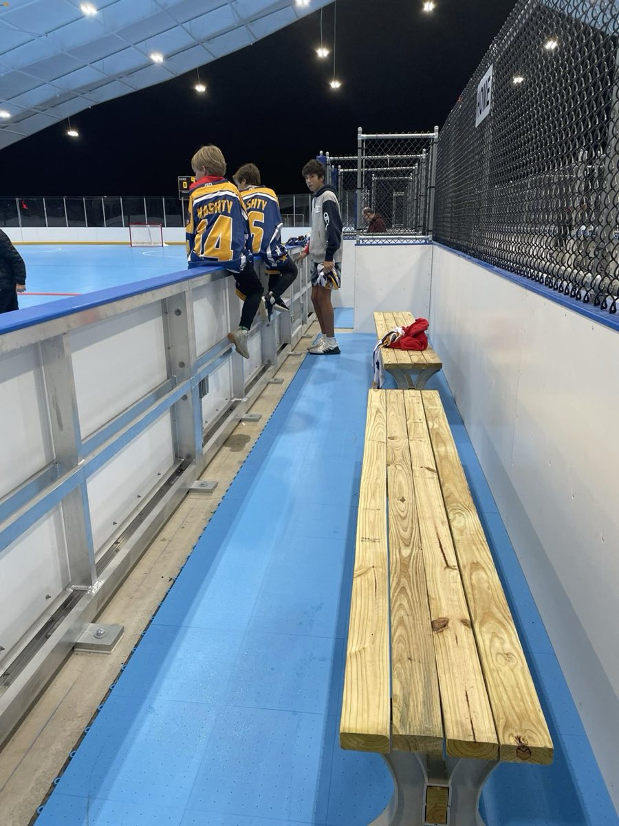 Young HIHA players on the bench between shifts